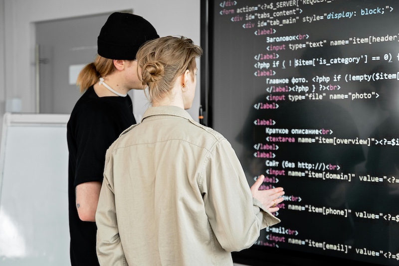 Software developers working through complicated code